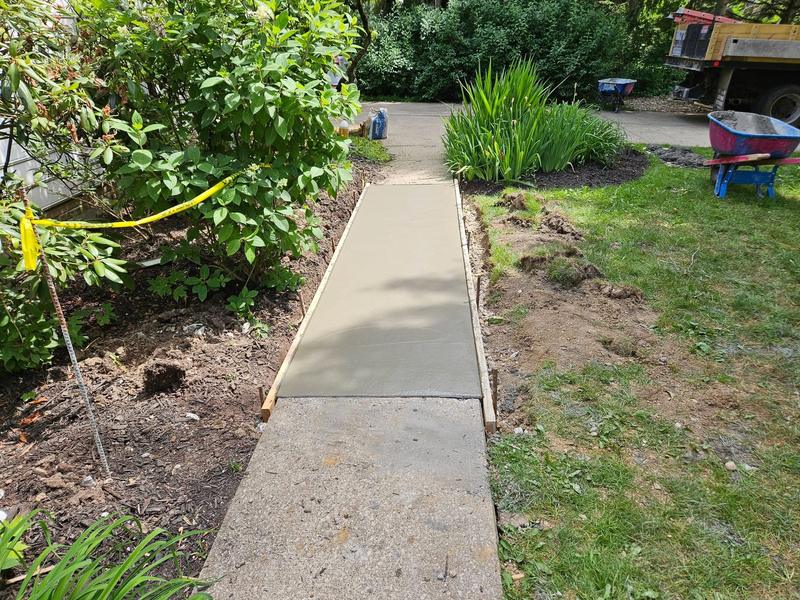 Fresh concrete walkway next to an existing sidewalk