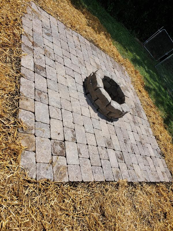 Tumbled paver patio with a built-in paver fire pit by CS & Sons Concrete