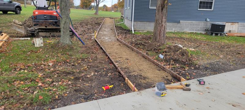 Excavation and forming for a new concrete walkway on a CS & Sons job site