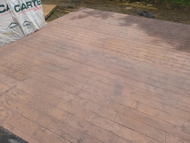 Wood-plank stamped concrete patio stained a rich reddish brown by CS & Sons Concrete